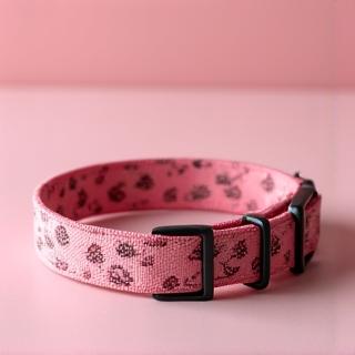 A stylish dog collar with an intricate rose floral pattern on soft fabric.